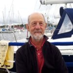 Man standing in front of a harbour