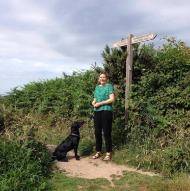 lady with dog on a footpath