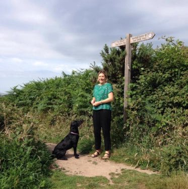 lady with dog on a footpath