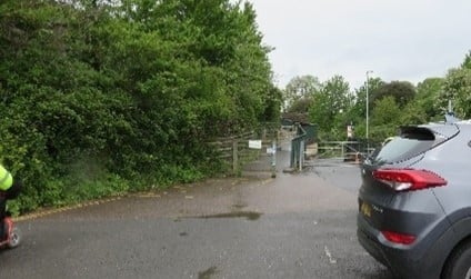 A car park with a ramp leading up to a bridge.
